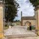 Superato l�ingresso del cimitero di Casamassima, accediamo a una zona alberata con al centro un�area lastricata. Qui sorge la chiesa di Santa Maria del Soccorso